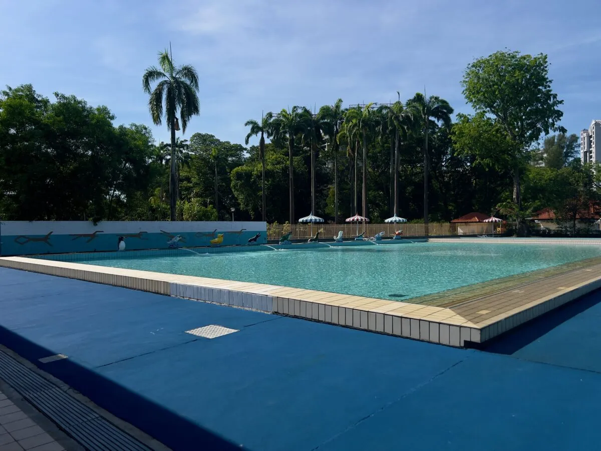 Swimming pool with palm trees and animal water sculptures at Katong Swimming Complex
